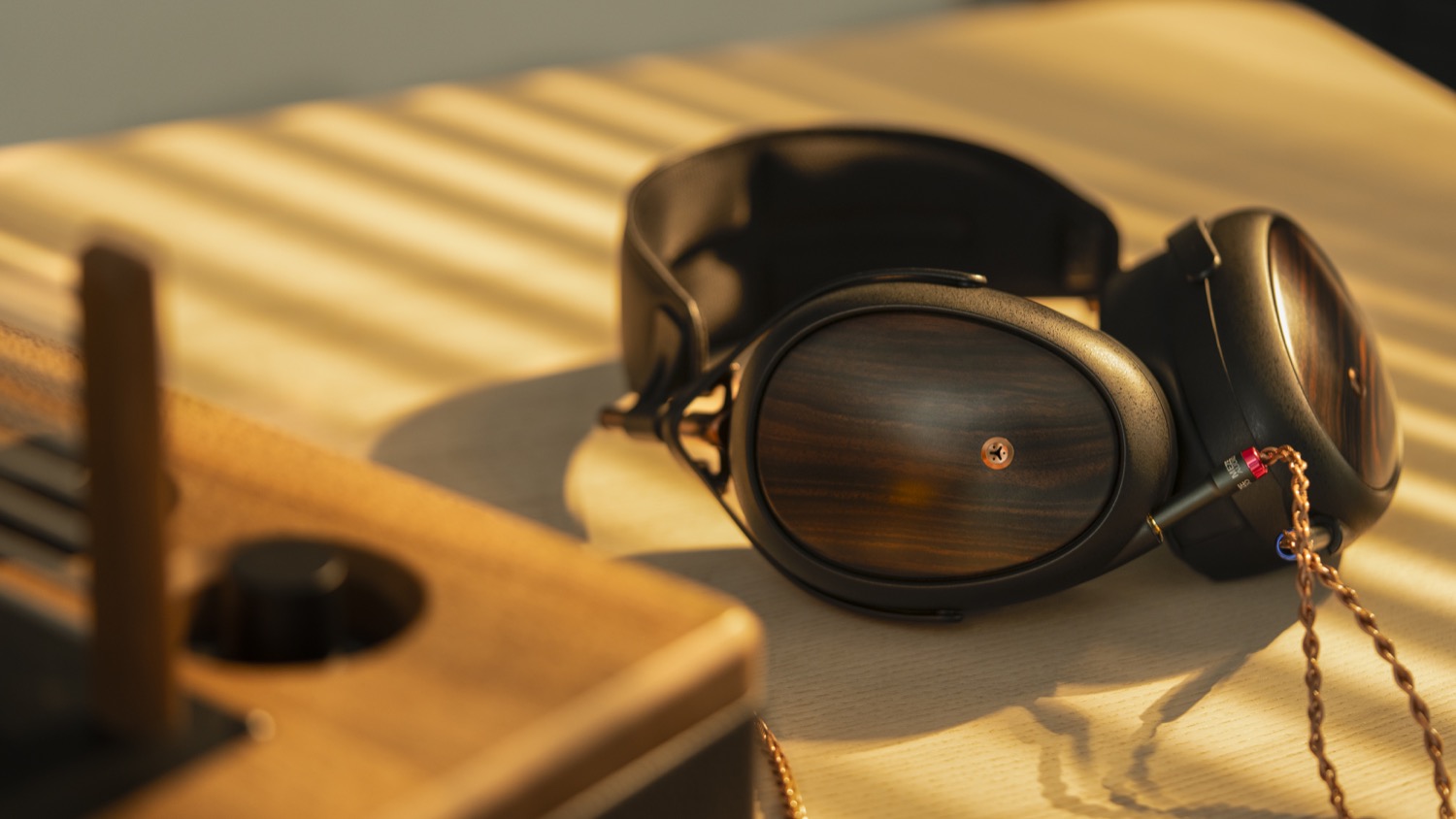 Photo of Meze Liric on desk with out of focus amplifier in foreground